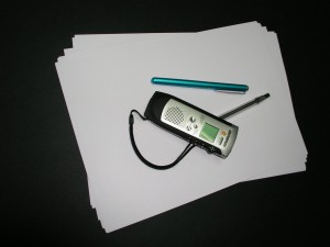 Dictaphone, pen and paper for recording oral history.