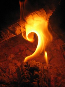 Photograph of an almost question mark in a campfire flame, accompanying "Tell Me an Old Story" - a Thursday Thoughts blogpost from historytrace exploring what lies behind your family lore and oral traditions. Copyright www.freeimages.com / Rachel Kirk.